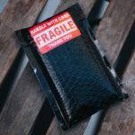 a wallet sitting on top of a wooden bench